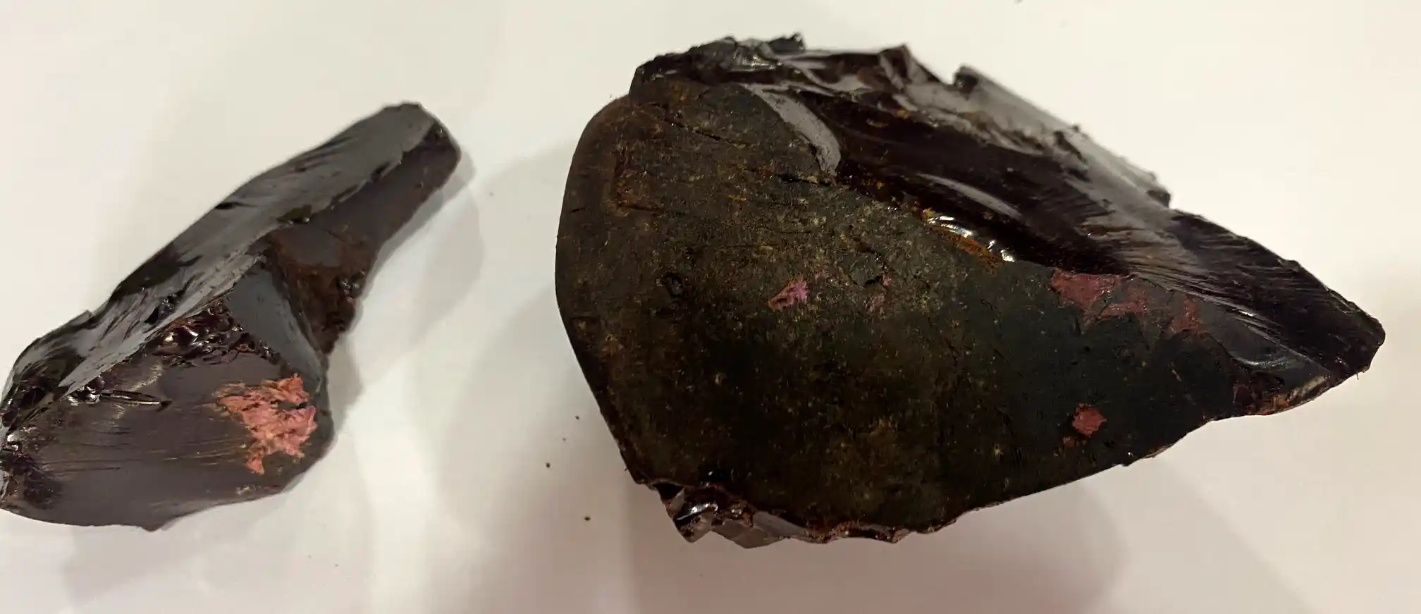Close-up of natural Himalayan Shilajit resin in a small glass jar with a wooden spoon, showcasing its dark, tar-like texture. Known for its energy-boosting and rejuvenating properties, Shilajit is a traditional Ayurvedic supplement rich in minerals and fulvic acid, sourced from the high mountains of Nepal.
